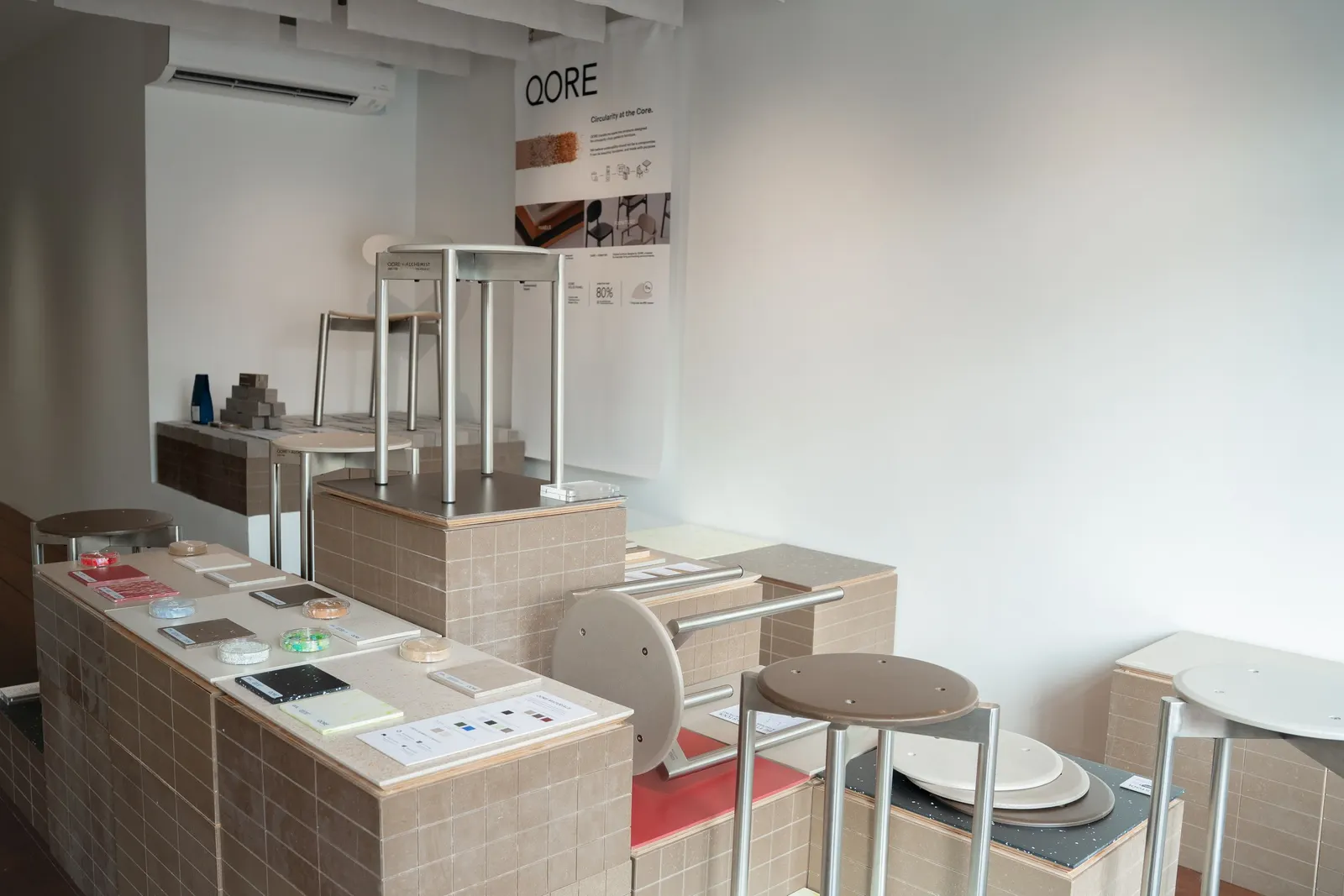 The Level 2 showcase, with material samples, panels and Betterism Stools