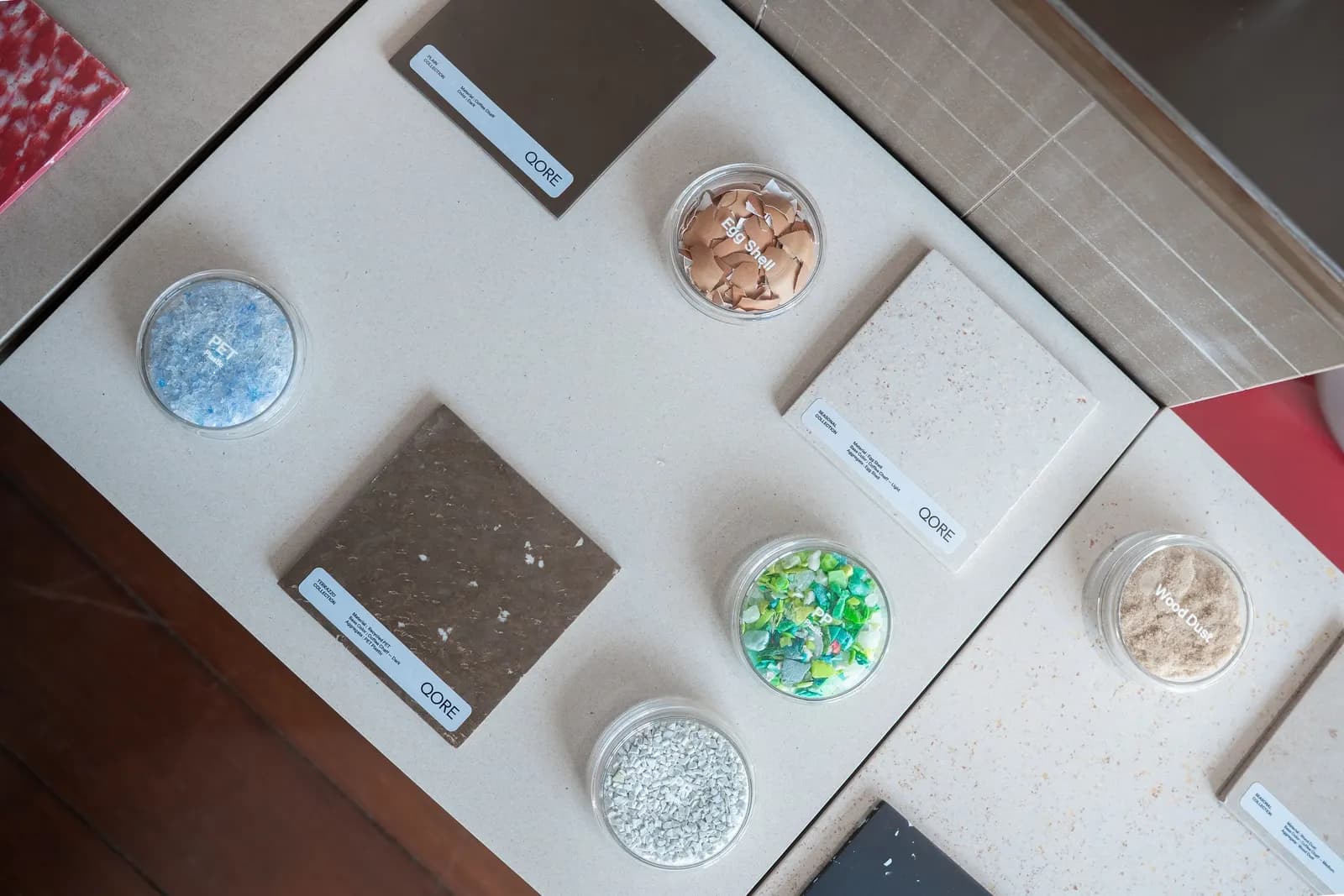 Samples of coffee chaff, recycled plastic and the QORE panels made from them