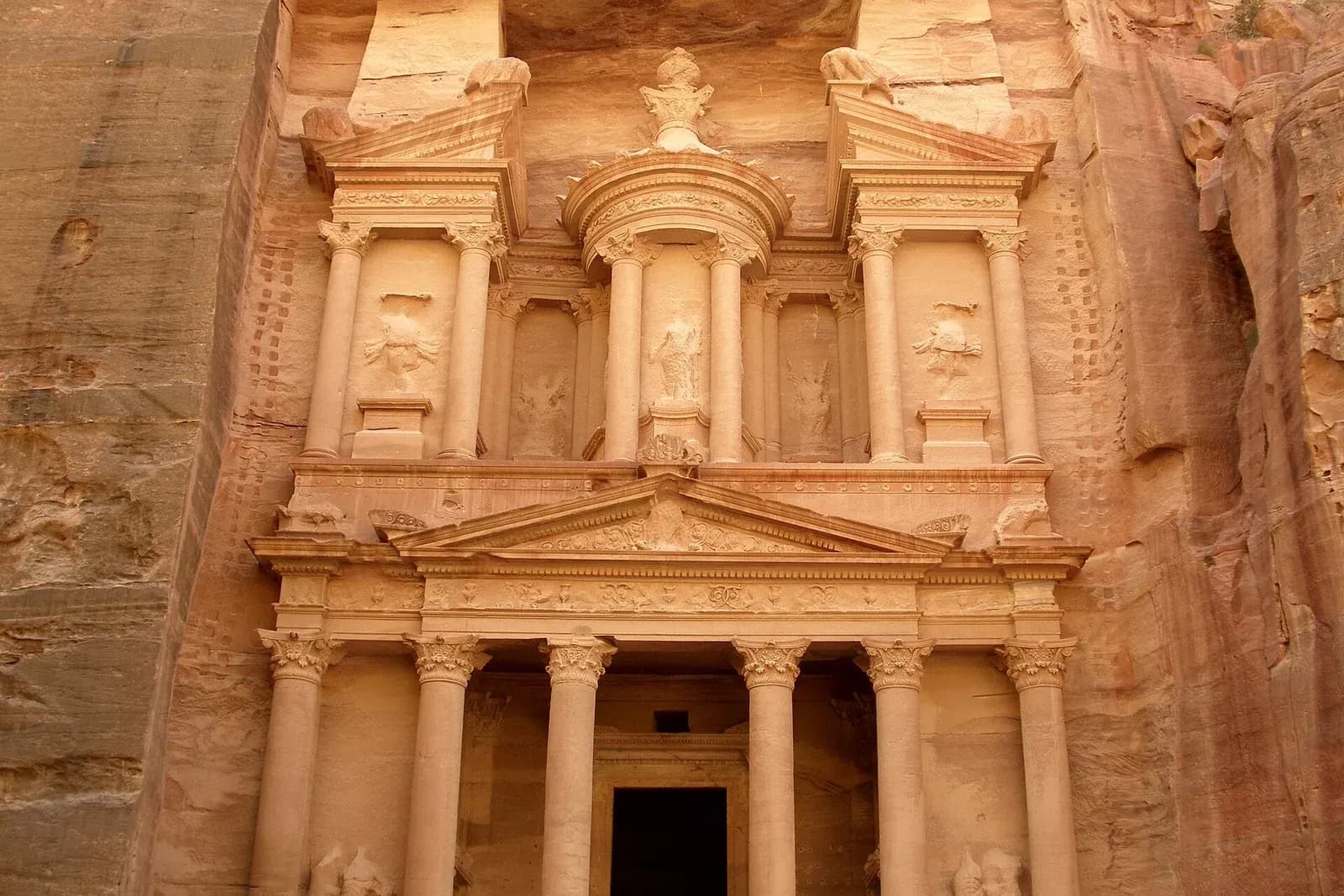 The Treasury (Al-Khazneh) carved into a rose-coloured sandstone cliff at Petra, Jordan